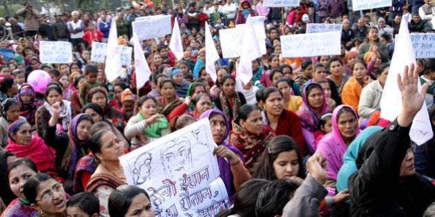 ROHTAK, INDIA - FEBRUARY 8: Civil society members headed by two Nepalese organisations conducting candle march, demanding speedy investigation into the gang rape and murder of a mentally challenged woman at Mansarovar park, on February 8, 2015 in Rohtak, India. Police say they are investigating the case and that they will catch the guilty soon. The candle light vigil also protested the perceived inaction of the police in the case, given that no arrests have been made after the victim was found dead in a field near Bahu Akbarpur village. The woman's body was found without key organs along with sticks, stones and condoms stuffed into her private parts three days after she went missing. (Photo by Manoj Dhaka/Hindustan Times via Getty Images)