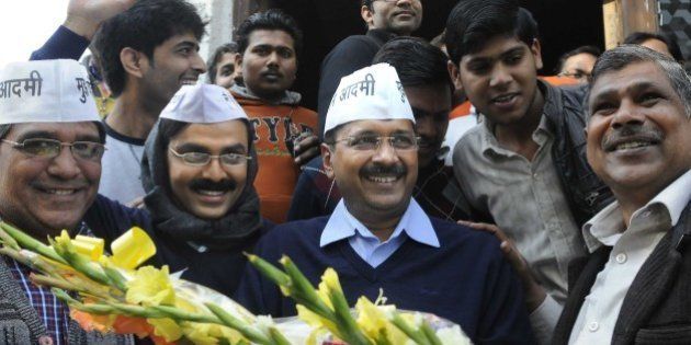NEW DELHI, INDIA - FEBRUARY 8: AAP leader Arvind Kejriwal with his look alike Jitendra Kumar, actor after programme recording at Kaushambi, Ghaziabad on February 8, 2015 in New Delhi, India. The former Delhi chief minister obliged his admirers and posed for pictures and selfies with them. According to exit polls, AAP appears set for a sweeping victory in the Delhi Assembly elections for which voting took place. (Photo by Sushil Kumar/Hindustan Times via Getty Images)