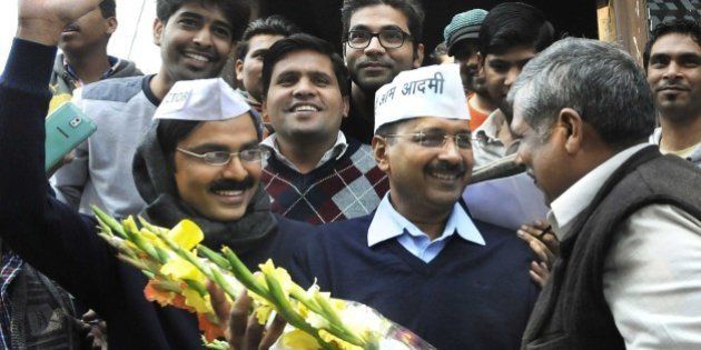 NEW DELHI, INDIA - FEBRUARY 8: AAP leader Arvind Kejriwal with his look alike Jitendra Kumar, actor after programme recording at Kaushambi, Ghaziabad on February 8, 2015 in New Delhi, India. The former Delhi chief minister obliged his admirers and posed for pictures and selfies with them. According to exit polls, AAP appears set for a sweeping victory in the Delhi Assembly elections for which voting took place. (Photo by Sushil Kumar/Hindustan Times via Getty Images)