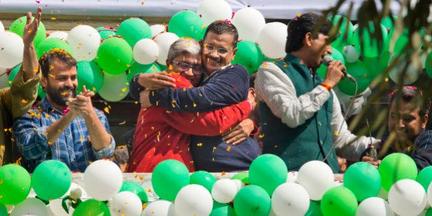 Aam Aadmi Party, or Common Manâs Party, leaders Arvind Kejriwal, center, and Ashutosh, second left, hug as they celebrate news of their party's performance in New Delhi, India, Tuesday, Feb. 10, 2015. The upstart anti-corruption party appeared set to install a state government in India's capital in a huge blow for Prime Minister Narendra Modi's Hindu nationalist party. As early trends pointed to an overwhelming win for the AAP, the party's jubilant supporters began cheering and dancing in celebration, yelling