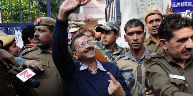 Aam Aadmi Party, or Common Man's Party, leader Arvind Kejriwal waves to residents as he comes out of a polling station after casting his vote in New Delhi, India, Saturday, Feb. 7, 2015. Voters cast ballots in the Indian capital on Saturday in an election that is seen as a litmus test for the popularity of Prime Minister Narendra Modi and his Hindu nationalist party. Opinion polls ahead of the vote to choose New Delhi's 70-member assembly suggest that Modi's Bharatiya Janata Party is either locked in a close contest with the upstart Common Man's Party or will come in second. (AP Photo/Altaf Qadri)