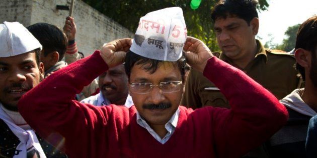 Aam Aadmi Party, or Common Man Party, leader Arvind Kejriwal, adjusts his cap while campaigning ahead of Delhi state elections in New Delhi, India, Thursday, Feb. 5, 2015. Delhi goes to the polls on Feb. 7. (AP Photo/Saurabh Das)