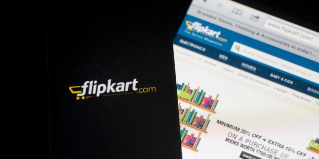 Flipkart's application loading page, left, and website are displayed on an Apple Inc. iPhone 5c and iPad respectively in an arranged photograph in Hong Kong, China, on Wednesday, May 21, 2014. Flipkart, India's largest online retailer, will buy competitor Myntra.com, according to people with knowledge of the talks, to gain a business with higher margins and strengthen its position in the local market against Amazon.com Inc. Photographer: Brent Lewin/Bloomberg via Getty Images