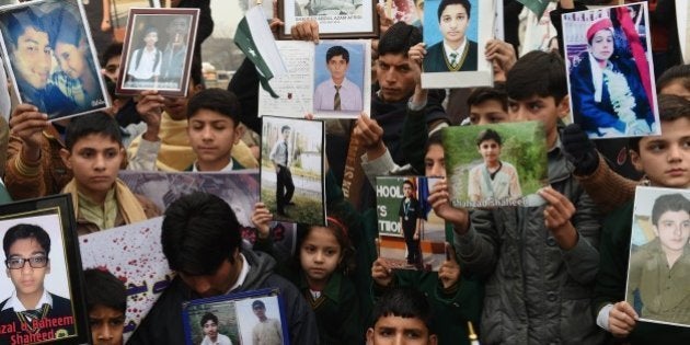 Pakistani relatives of schoolchildren killed in a Taliban attack on the Army Public School (APS) protest against delays in the investigation in Peshawar on February 7, 2015. Hundreds of parents, students and civil society members Saturday protested outside a Pakistani school over 'sluggish' investigation into a massacre in which 153 people were killed, witnesses said. AFP PHOTO / A MAJEED (Photo credit should read A Majeed/AFP/Getty Images)