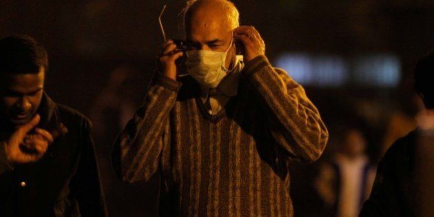NEW DELHI, INDIA - FEBRUARY 17: A man wearing a mask as a precaution measure against swine flu virus, at a RML hospital on February 17, 2013 in New Delhi, India. According to local reports, two more people succumbed to swine flu in the city, taking the death toll to nine. (Photo by Sanjeev Verma/Hindustan Times via Getty Images)