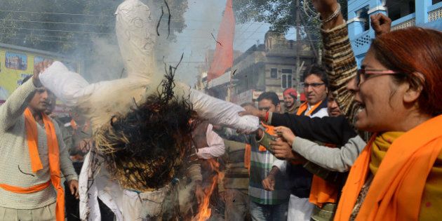 Activists of Vishva Hindu Parishad (VHP), Bajrang Dal and The Durga Vahini (Army of Durga) shout slogans as they burn an effigy during a demonstration denouncing Valentine's Day in Amritsar on February 14, 2013. Hindu organizations strongly oppose Valentine's Day celebrations citing them as a cultural invasion of the conservative nation. AFP PHOTO /NARINDER NANU (Photo credit should read NARINDER NANU/AFP/Getty Images)