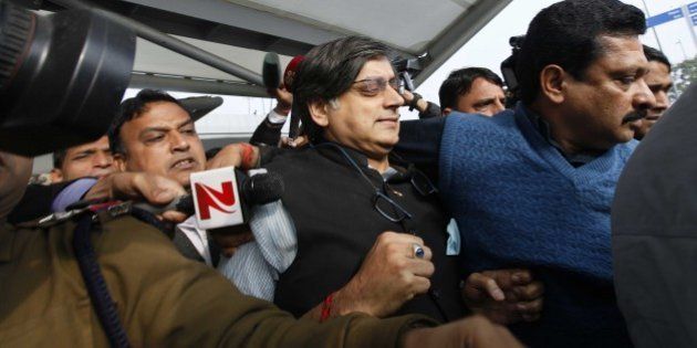 NEW DELHI, INDIA - JANUARY 11: Congress Leader Shashi Tharoor arrives at T3 terminal of IGI Airport after returning from Kerala, on January 11, 2015 in New Delhi, India. Tharoor was undergoing treatment for spondylitis at an Ayurvedic clinic in Kerala. In his first statement to the police days after the death of Sunanda Pushkar, Shashi Tharoor admitted they had had a 'small misunderstanding' but that was 'cleared' and that their married life was 'very happy'. As the probe into the mysterious death of Sunanda Pushkar picks up momentum, Tharoor returned to the capital and asserted it was his duty to cooperate in the investigation. (Photo by Raj K Raj/Hindustan Times via Getty Images)