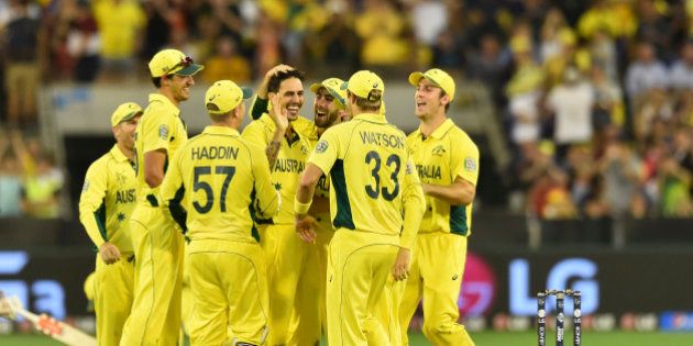 Australia's Mitchell Johnson center, is congratulated by team mates after taking a wicket during their Cricket World Cup pool A match against England in Melbourne, Australia, Saturday, Feb. 14, 2015. (AP Photo/Theo Karanikos)