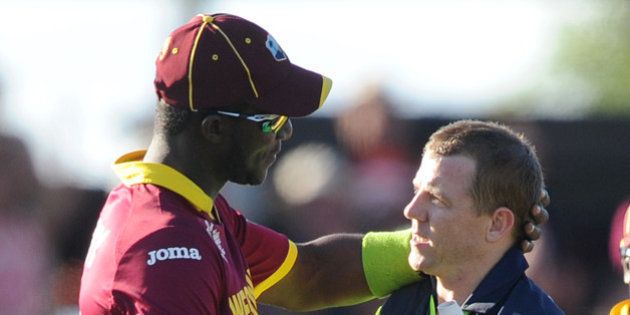 Ireland's Niall O'Brien, right, shakes hands with West Indies' Darren Sammy at the end of their Cricket World Cup pool B match at Nelson, New Zealand, Monday, Feb. 16, 2015. Ireland wins the match with 4 wickets and 25 balls to spare. (AP Photo/Ross Setford)