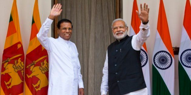 Sri Lankaâs President Maithripala Sirisena, left, and Indian Prime Minister Narendra Modi wave during a photo opportunity in New Delhi, India, Monday, Feb. 16, 2015. Sri Lanka's new leader is underlining India's importance as a regional ally by making it his first official foreign destination as president, following years of uneasy relations with New Delhi and international pressure to speed up post-civil war reconciliation efforts at home. (AP Photo/Saurabh Das)