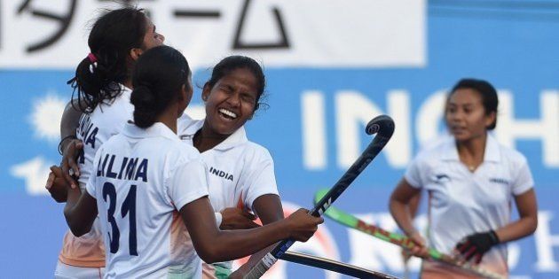 India's Vandana Kataria (L) celebrates a goal against Japan with Lilima Minz (2L) and teammates during their women's field hockey bronze medal match at the Seonhak Hockey Stadium during the 17th Asian Games in Incheon on October 1, 2014. AFP PHOTO / PRAKASH SINGH (Photo credit should read PRAKASH SINGH/AFP/Getty Images)