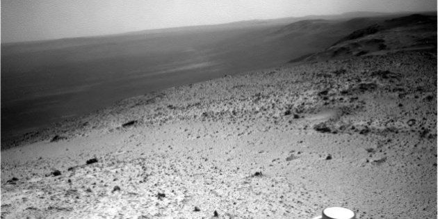 This image sent by NASAâs Opportunity rover on Wednesday, Jan. 7, 2015 shows a view from atop a Martian hill. Opportunity will spend several days at the summit making pictures that engineers will stitch into a color panorama. (AP Photo/NASA)