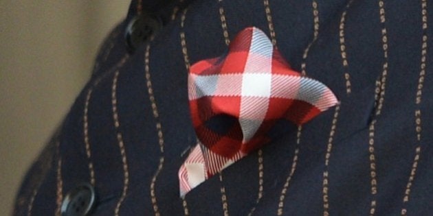 This photograph taken on January 25, 2015, shows detail on Indian Prime Minister Narendra Modi's suit bearing his own name during a joint press conference after delegation level talks with US President Barack Obama in New Delhi. Narendra Modi's daring fashion choices have won plaudits in the past, but the Indian leader's decision to wear a suit with his own name printed all over it sparked a barrage of mockery on social media. AFP PHOTO / PRAKASH SINGH (Photo credit should read PRAKASH SINGH/AFP/Getty Images)