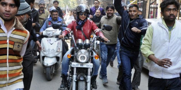 NEW DELHI, INDIA - JANUARY 29: Bollywood actress and AAP leader Gul Panag rides bike during election campaign for the party candidate at Shashtri Nagar area for the upcoming Delhi Assembly elections 2015 on January 29, 2015 in New Delhi, India. Polling in Delhi will be held on February 7 and the counting of votes will take place on February 10. (Photo by Subrata Biswas/Hindustan Times via Getty Images)