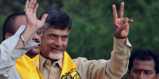 Telugu Desam Party (TDP) President and former Chief Minister of Andhra Pradesh state, N. Chandrababu Naidu, second left, greets his supporters during an election campaign rally in Hyderabad, India, Monday, April 14, 2014. The multiphase voting across the country runs until May 12, with results for the 543-seat lower house of parliament announced May 16. (AP Photo/Mahesh Kumar A.)