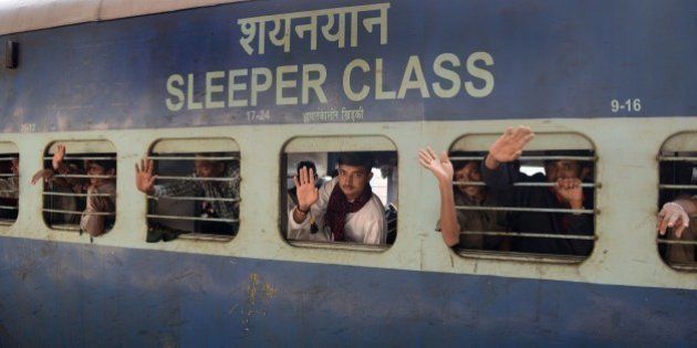 Indian fishermen, who were imprisoned in a Pakistani jail, wave as their train pulls out of the railway station in Ahmedabad on February 19, 2015. Some 172 Indian fishermen arrived in the city after they were released from a Pakistani jail. Fishermen are often arrested for violating the International Maritime Boundary Line (IMBL), mainly in the Arabian Sea, due to poorly-marked water boundaries and ill-equipped boats that lack the technology to specify exact locations. AFP PHOTO / Sam PANTHAKY (Photo credit should read SAM PANTHAKY/AFP/Getty Images)
