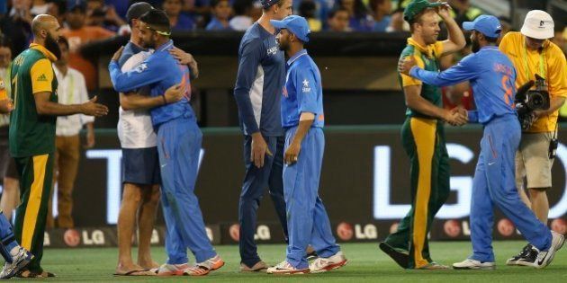 Indian players in blue, and South African players greet each other after Indian won the Cricket World Cup pool B match in Melbourne, Australia, Sunday, Feb. 22, 2015. (AP Photo/Rick Rycroft)