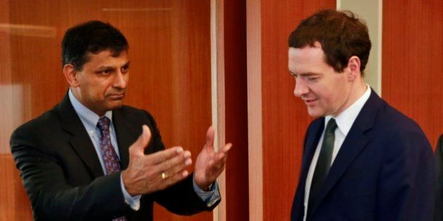 Reserve Bank of India (RBI) Governor Raghuram Rajan, left, and Britain's Chancellor of the Exchequer George Osborne arrive for a meeting at RBI headquarters in Mumbai, India, Monday, July 7, 2014. Osborne is on a two day official visit to India. (AP Photo/Rafiq Maqbool)