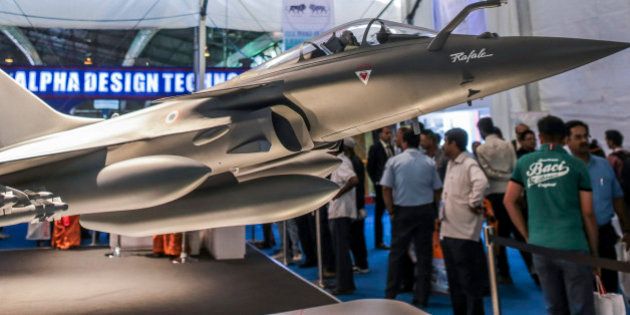 A model of Rafale multirole fighter aircraft, manufactured by Dassault Aviation SA., stands on display during the Aero India 2015 air show at Air Force Station Yelahanka, in Bengaluru, India, on Thursday, Feb 19, 2015. The bi-annual Aero India exhibit is the premier event for nations and companies to get a piece of the $150 billion that the world's biggest arms importer plans to spend on modernizing its military. Photographer: Dhiraj Singh