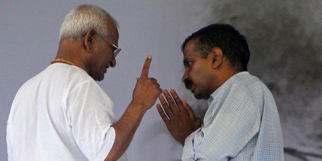 India's anti-corruption activist Anna Hazare, left, speaks with supporter Arvind Kejriwal on the 8th day of his hunger strike in New Delhi, India, Tuesday, Aug. 23, 2011. The government called Tuesday for India's political parties to reach consensus on drafting anti-corruption legislation, as an activist leading anti-graft protests entered the second week of his hunger strike. (AP Photo/Gurinder Osan)