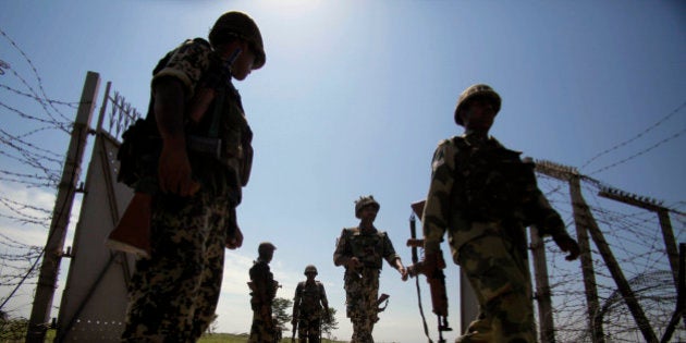 FILE - In this Monday, Sept. 16, 2013 file photo, Indiaâs Border Security Force (BSF) soldiers patrol near the India-Pakistan international border fencing at Garkhal, about 35 kilometers (22 miles) west of Jammu, India. The two countries regularly blame each other for starting skirmishes, But they agree the violence has escalated to its highest level - killing dozens of troops and civilians on both sides - since a 2003 ceasefire agreement. (AP Photo/Channi Anand, File)