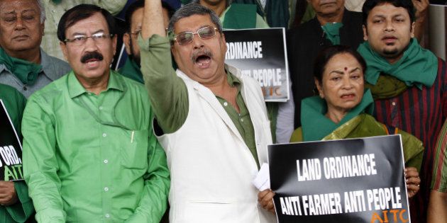 NEW DELHI, INDIA - FEBRUARY 24: Trinamool Congress MPs staged a protest against the Land Acquisition Bill outside the Parliament during budget session on February 24, 2015 in New Delhi, India. The government introduced the land acquisition amendment bill in the Lok Sabha amid an uproar by the opposition. (Photo by Arvind Yadav/Hindustan Times via Getty Images)