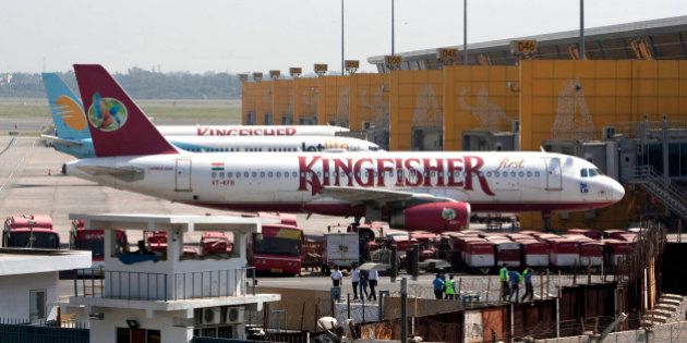 Kingfisher Airlines jets parked at the Indira Gandhi international airport in New Delhi, India, Tuesday, Oct. 2, 2012. Kingfisher Airlines grounded flights for at least three days after a violent strike over unpaid wages at the cash-strapped Indian carrier. (AP Photo/Tsering Topgyal)