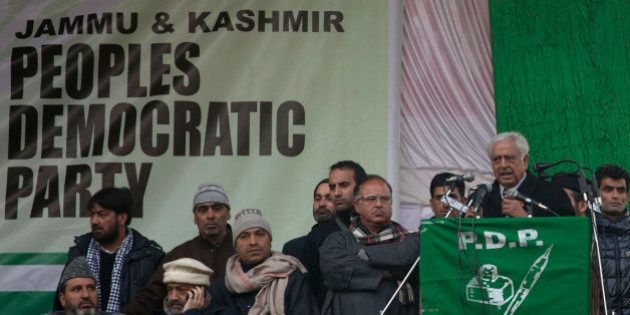 Peoples Democratic Party (PDP) leader Mufti Mohammad Sayeed, right, addresses an election campaign rally in Srinagar, Indian controlled Kashmir, Thursday, Dec. 11, 2014. The final two phases of the five-phased state elections of Jammu and Kashmir will be held on Dec. 14 and 20. (AP Photo/Dar Yasin)