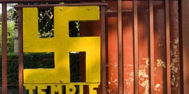 A swastika [in India the swastika as an important Hindu symbol that represents God (Brahman)], decorates a temple gate in Sarnath, India.
