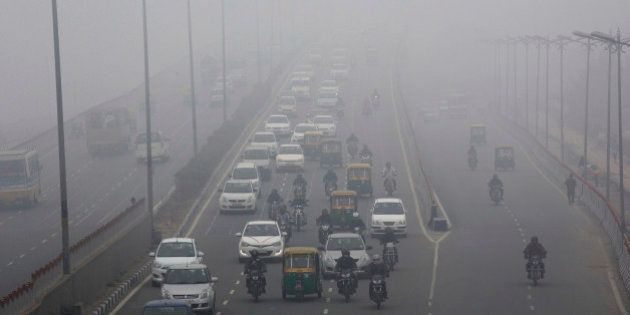 Traffic moves along a road shrouded in haze in New Delhi, India, on Monday, Jan. 20, 2014. India, China and Brazil, three of the largest developing nations, joined the U.S. in a list of the biggest historical contributors to global warming, according to a study by researchers in Canada. Photographer: Kuni Takahashi/Bloomberg via Getty Images