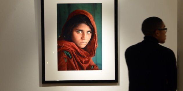 'Afghan Girl, 1984' by photographer Steve McCurry (estimate- USD $30,000 to $50,000) on display as part of 'The National Geographic Collection: The Art of Exploration' at Christie's November 30, 2012 in New York. Fine art from the archives of the National Geographic Society will be auctioned on December 6. AFP PHOTO/Stan HONDA (Photo credit should read STAN HONDA/AFP/Getty Images)