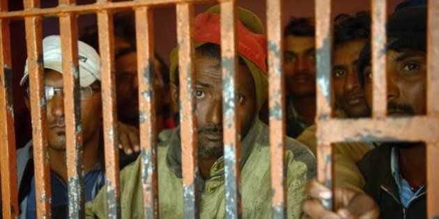 Arrested Indian fishermen stand in a police lockup in the port city of Karachi on January 22, 2015. Pakistani marine forces have arrested 38 Indian fishermen for violating territorial waters in the Arabian Sea, police said. AFP PHOTO / Rizwan TABASSUM (Photo credit should read RIZWAN TABASSUM/AFP/Getty Images)
