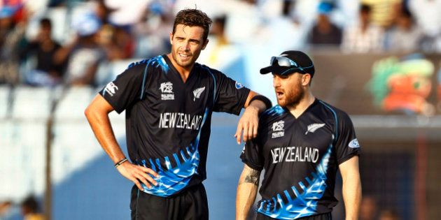 New Zealand's Tim Southee, left, stands with his team captain Brendon McCullum after taking the wicket of South Africa's Albie Morke during their ICC Twenty20 Cricket World Cup match in Chittagong, Bangladesh, Monday, March 24, 2014. (AP Photo/A.M. Ahad)