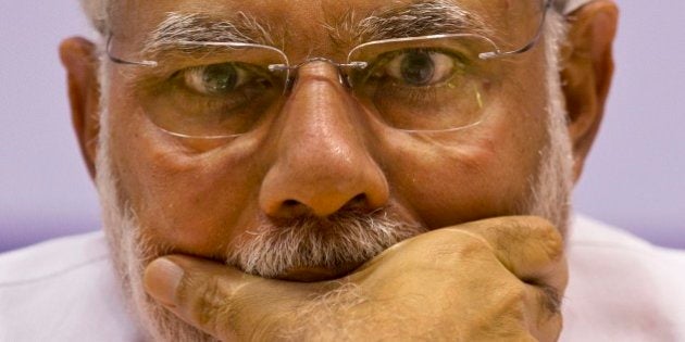 Indian Prime Minister Narendra Modi, listens to a speaker as he attends a function to mark recent canonization of two Indians by the Vatican in New Delhi, India, Tuesday, Feb. 17, 2015. Indian saints Eufrasia Eluvathingal and Kuriakose Elias Chavara were canonized by Pope Francis in November last year. Amidst the controversies on attacks against churches in northern India, Modi Tuesday assured the minorities that his government will not tolerate any overt or covert disruption of Indian secularism. (AP Photo/Saurabh Das)