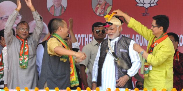 ITANAGAR, INDIA - MARCH 31: BJP Prime Ministerial candidate Narendra Modi welcomed by local leaders during campaign rally for Lok Sabha election 2014 at Indira Gandhi Park on March 31, 2014 in Itanagar, India. Taking the battle to Congress traditional base of Arunachal Pradesh, Narendra Modi attacked the Congress, saying there is no future due to their false promises. (Photo by Subrata Biswas/Hindustan Times via Getty Images)