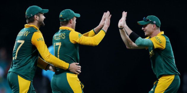 South Africa's AB De Villiers is congratulated by teammates Dale Steyn, right, and Rilee Rossouw, left, after taking a catch to dismiss West Indies Jonathan Carter during their Cricket World Cup Pool B match in Sydney, Australia, Friday, Feb. 27, 2015. (AP Photo/Rick Rycroft)
