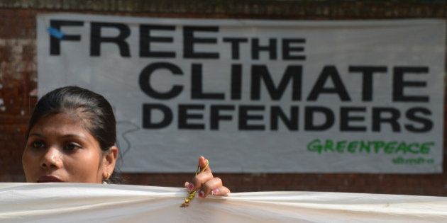 A Greenpeace activist demonstrates during a 30-hour long protest in New Delhi on November 16, 2013, to demand the release of a group of Greenpeace activists being held in Russia. The so-called 'Arctic 30' were detained when the Russian Coast Guard boarded their Dutch-flagged Greenpeace vessel after several activists scaled a state-owned oil platform on September 18 in a protest. AFP PHOTO/RAVEENDRAN (Photo credit should read RAVEENDRAN/AFP/Getty Images)