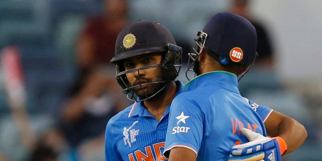 India's Virat Kohli right congratulates Rohit Sharma after he hit a half century during their Cricket World Cup Pool B match against the United Arab Emirates in Perth, Australia, Saturday, Feb 28, 2015. (AP Photo/Theron Kirkman)