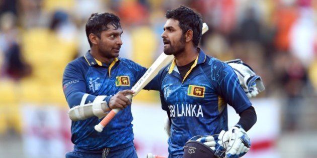 Sri Lanka batsmen Kumar Sangakkara (L) and Lahiru Thirimanne (R) celebrate after hitting the winning runs against England during their 2015 Cricket World Cup Group A match in Wellington on March 1, 2015. AFP PHOTO / William WEST (Photo credit should read WILLIAM WEST/AFP/Getty Images)