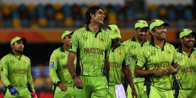 Pakistan's players smile as they walk back after defeating Zimbabwe in the Pool B Cricket World Cup match in Brisbane, Australia, Sunday, March 1, 2015. (AP Photo/Tertius Pickard)