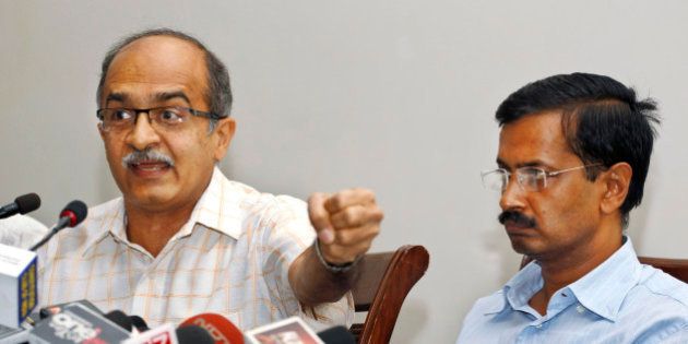 Prashant Bhushan, left, and Arvind Kejriwal, associates of Anna Hazare, India's most prominent anti-corruption activist, elaborate evidences of corruption collected against 15 ministers serving in the present government, including its leader and Prime Minister Manmohan Singh, at a press conference in New Delhi, India, Saturday, May 26, 2012. Files containing evidences of corruption have been sent to Singh, asking him to constitute an investigation team of eminent judges to verify their claims. (AP Photo/ Saurabh Das)