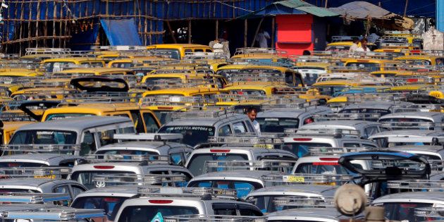 In this Tuesday, March 25, 2014 photo, traditional black-and-yellow licensed cabs and private cabs stand at a parking lot at the airport in Mumbai, India. Taxi-hailing smartphone app Uber is making a big push into Asia with the company starting operations in 18 cities in Asia and the South Pacific including Seoul, Shanghai, Bangkok, Hong Kong and five Indian cities in the last year. (AP Photo/Rajanish Kakade)