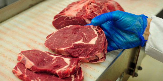 An employee selects cuts of Irish rib-eye beef steak as they work on the packaging line at ABP Foods Group's meat processing plant in Cahir, Ireland, on Wednesday, Jan. 14, 2015. The U.S., the world's biggest beef consumer, is lifting a ban on imports from Ireland more than 15 years after mad cow disease spurred restrictions of supplies from Europe. Photographer: Aidan Crawley/Bloomberg via Getty Images