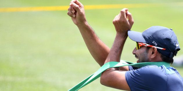 India's Mohammed Shami uses a rubber band to stretch out during training for their cricket test match against Australia in Sydney, Sunday, Jan. 4, 2015. Their final test of the series begins on Jan. 6 with Australia leading the series 2-0. (AP Photo/Rick Rycroft)