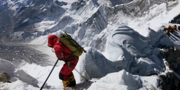FILE - In this May 18, 2013 file photo released by Alpenglow Expeditions, a climber prepares to descend the Hillary Step as he makes his way down from the summit of Mount Everest, in the Khumbu region of the Nepal Himalayas. Nepal will slash the climbing fees for Mount Everest to attract more mountaineers to the world's highest peak, even as concerns grow about the environmental effects of thousands of climbers who already crowd the mountain during the high season. Madhusudan Burlakoti, head of Nepal's Department of Mountains, said Friday, Feb. 14, 2014 that beginning next year, it will cost $11,000 per climber to climb Everest. (AP Photo/Alpenglow Expeditions, Adrian Ballinger, File) MANDATORY CREDIT, EDITORIAL USE ONLY