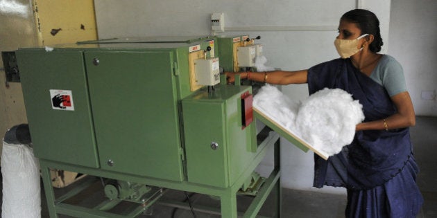 Members of Self Employed Women's Association (SEWA) make low cost sanitary pads at their facility in Ahmedabad on September 3, 2012. Prompted by the widespread suffering of women and girls in rural areas who continue to be plagued by unhygienic old cloth pieces or rags during their menstrual cycle periods, SEWA has began manufacturing low cost sanitary pads with the current production capacity at 2,000 pads per day. The price of each sanitary pad will be about one Indian rupee. AFP PHOTO / Sam PANTHAKY (Photo credit should read SAM PANTHAKY/AFP/GettyImages)