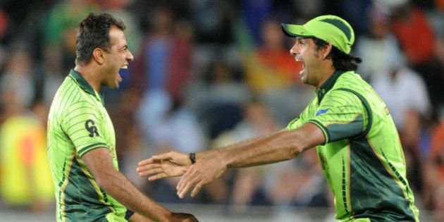 Pakistan's Wahab Riaz, left, runs to his teammate Mohammad Irfan as they celebrate their 29 run win over South Africa in their Cricket World Cup Pool B match in Auckland, New Zealand, Saturday, March 7, 2015. (AP Photo/Ross Setford)