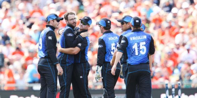 NAPIER, NEW ZEALAND - MARCH 08: Daniel Vettori of New Zealand is congratulated on taking his 300th career ODI wicket to dismiss Nawroz Mangal of Afghanistan during the 2015 ICC Cricket World Cup match between New Zealand and Afghanistan at McLean Park on March 8, 2015 in Napier, New Zealand. (Photo by Hagen Hopkins/Getty Images)