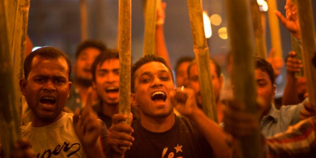 Activists of All Assam Minorities Students Union shout slogans during a torch protest against the lynching of a man accused of rape in Gauhati, in the northeastern Indian state of Assam, Saturday, March 7, 2015. The government of northeastern India's Nagaland state has suspended three officials and deployed paramilitary soldiers after a mob stormed a high-security jail, dragged away the man and then lynched him, officials said Saturday. The incident has sparked protests in the neighboring state of Assam, where the man, identified as Farid Khan, was from. (AP Photo/ Anupam Nath)