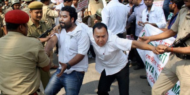 Indian policemen detain activists of Asomiya Yuva Mancha (AYM) during a protest against the lynching of a man accused of rape in front of Nagaland House in Gauhati, in the northeastern Indian state of Assam, Saturday, March 7, 2015. The government of northeastern India's Nagaland state has suspended three officials and deployed paramilitary soldiers after a mob stormed a high-security jail, dragged away the man and then lynched him, officials said Saturday. The incident has sparked protests in the neighboring state of Assam, where the man, identified as Farid Khan, was from. (AP Photo/Press Trust of India)